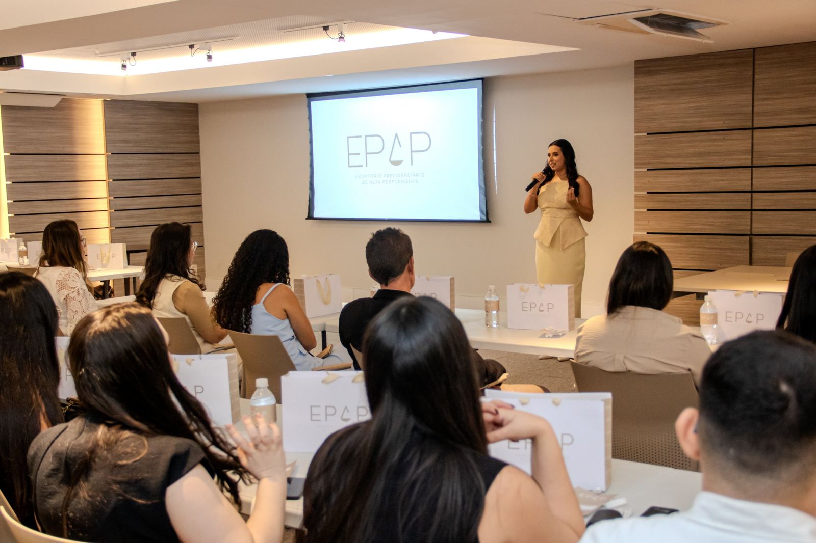 Sara Leite falando para a turma, com o logo da EPAP no telão